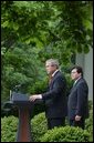 As Counsel Judge Alberto Gonzales stands by his side, President George W. Bush delivers remarks regarding his judicial nominations in the Rose Garden Friday, May 9, 2003.  White House photo by Tina Hager