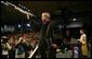 President George W. Bush waves to the audience after being awarded an honorary doctorate degree from Dr. Patrick Ferry at the commencement ceremonies for Concordia University near Milwaukee, Wis., Friday, May 14, 2004.  White House photo by Paul Morse