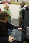 Lead author Keri Hornbuckle, left in green sweater, discussed the equipment installation with van driver Roger Peck while UI graduate student Andres Martinez, foreground, enters data.