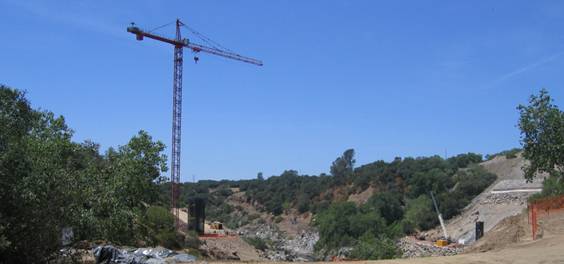 static image:  photo of the crane at the left abutment and the retaining wall on the right abutment