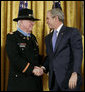 President George W. Bush shakes hands with U.S. Army Major Bruce P. Crandall after awarding Crandall the Medal of Honor in a ceremony in the East Room of the White House, Monday, Feb. 26, 2007, for his extraordinary heroism as a 1st Cavalry helicopter flight commander, completing 22 flights under intense enemy fire to aid troops in the Republic of Vietnam in November 1965. White House photo by Eric Draper