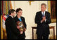 President George W. Bush leads the applause in honor of Private First Class Ross A. McGinnis, U.S. Army, after presenting the Congressional Medal of Honor posthumously to his parents, Tom and Romayne McGinnis, of Knox, Pennsylvania, during ceremonies Monday, June 2, 2008, at the White House. White House photo by Chris Greenberg