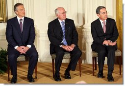 Former Prime Minister Tony Blair of the United Kingdom, is joined by Australia's former Prime Minister John Howard and Colombian President Alvaro Uribe as they sit onstage in the East Room of the White House Tuesday, Jan. 13, 2009, during a ceremony honoring them as 2009 recipients of the Presidential Medal of Freedom. Established by Executive Order in 1963, the medal is America's highest civil award. White House photo by Chris Greenberg