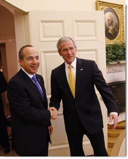 President George W. Bush greets Mexico's President Felipe Calderon for their meeting Tuesday, Jan. 13, 2009, in the Oval Office at the White House. White House photo by Eric Draper