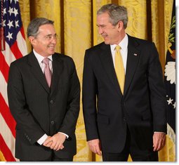 President George W. Bush stands with Colombian President Alvaro Uribe Tuesday, Jan. 13, 2009, during ceremonies honoring the 2009 Presidential Medal of Freedom Recipients in the East Room of the White House.  White House photo by Chris Greenberg