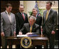 President George W. Bush is joined by U.S. Secretary of Health & Human Services Michael O. Leavitt, right, former Texas U.S. Representative Tom DeLay, left, U.S. Rep. Wally Herger, R-Calif., second from left and U.S. Sen. Mike DeWine, R-Ohio, in the Roosevelt Room of the White House, Monday, July 3, 2006, as President Bush signs H.R. 5403, the Safe and Timely Interstate Placement of Foster Children Act of 2006. White House photo by Kimberlee Hewitt