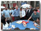 Arm in arm with Philadelphia Mayor John Street, President Bush passes out birthday cake at an urban block party in Philadelphia July 4, 2001. The President celebrates his 55th birthday July 6, 2001.