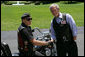 President George W. Bush poses for a photo with National Executive Director of Rolling Thunder Artie Muller at the conclusion of a visit by the motorcycle group to the White House. White House photo by Chris Greenberg