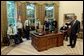 President George W. Bush talks with soldiers after taping his weekly radio address in the Oval Office Friday, May 16, 2003. Honoring Armed Forces Day on May 17th, the President invited soldiers to attend the recording of the address.  White House photo by Eric Draper