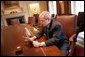 President George W. Bush records his radio address for a Saturday morning broadcast in the Cabinet Room of the White House Thursday, March 17, 2005.  White House photo by Eric Draper