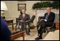 President George W. Bush and Andrew Natsios, Presidential Special Envoy for Sudan, meet with the press in the Oval Office Tuesday, Oct. 31, 2006. "The situation in Darfur is on our minds," said the President. "The people who have suffered there need to know that the United States will work with others to help solve the problem." White House photo by Kimberlee Hewitt