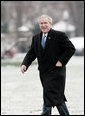 President George W. Bush makes his way across the South Lawn after arriving at the White House aboard Marine One from his weekend at Camp David, Md., Monday, Jan. 22, 2007. The President spent the weekend at the Presidential retreat preparing for his State of the Union address to be delivered before Congress Tuesday evening. White House photo by Paul Morse