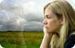 Depressed woman looking out of a window