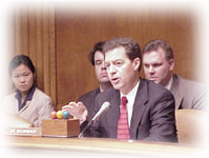 Sam speaks at a hearing committee regarding rural health care