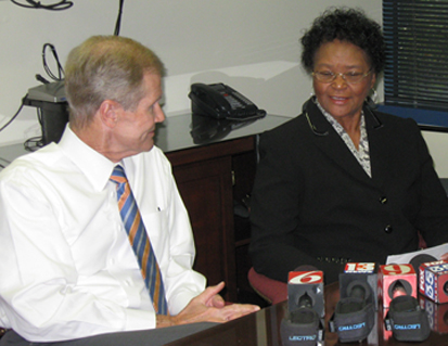 Mrs. Margaret Snow of Leesburg, Florida, right, widow of World War II veteran Samuel Snow receives a check from U.S. Sen. Bill Nelson for the back pay with interest Mr. Snow lost 64 years ago when he was wrongly convicted of a crime he didn't commit, imprisoned and tossed out of the service.