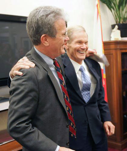 Sen. Tom Coburn, R-Okla., left, sings Elton John's "Rocket Man" with Sen. Bill Nelson, D-Fla. Sen. Coburn is paying off a bet to Sen. Nelson after the Florida Gators beat the Oklahoma Sooners in the BCS title game. 