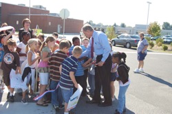 Senator Carper makes sure each child gets a piece of the ceremonial ribbon that was cut over the crosswalk.