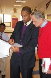 Senator Carper learns about his day from Principal and Founder, Jack Perry.