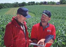 photo of NRCS conservationist discussing a conservation plan with a farmer