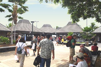 small thatch-roofed buildings bordering an open-air courtyard