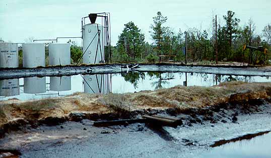 photo of site with collection lagoon and large white tanks