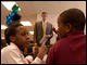 Secretary of Education Arne Duncan visited Amidon-Bowen Elementary School in Washington, D.C., on March 18, 2009, where he met Principal Almeta Hawkins (foreground) and Everybody Wins DC literacy program students.