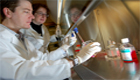 Edgar Charles performs experiments on blood cells from patients infected with the hepatitis C virus as mentor Lynn Dustin, an immunologist at the Rockefeller University in New York City, looks on.(Rockefeller University Photo/Zach Veilleux)