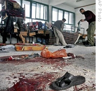 Palestinians inspect damage at UN school housing displaced people  after it was hit in Israeli shelling in Gaza, 17 Jan 2009