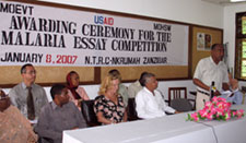 Photo of Permanent Secretary Jiddawi speaking about his experience in Washington at the Malaria Summit with left, Minister Suleiman and USAID Director Pamela White.