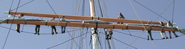 Volunteers learning the art of going aloft on the sailing ship Balclutha.