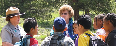 A ranger speaks to visitors in the park