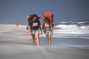 Two people walking along the beach at Assateague Island National Seashore