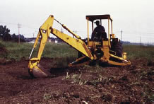 Worker using a backhoe