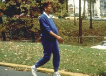 Photograph of a pregnant worker walking outdoors