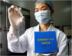 Masked scientist holding up vial (AP Images)