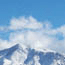 Clouds building over snowy peaks