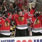 Blackhawks players, including team captain Jonathan Toews, cheering on the team.