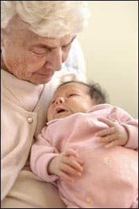 Elderly woman holding a baby