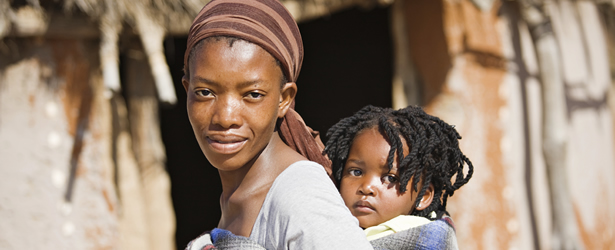 African woman with baby tied to her back.