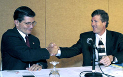 OSHA’s then-Assistant Secretary, John Henshaw and John Mayo, Dean, McDonough School of Business shake hands after signing a national Alliance on April 10, 2003.