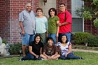 Family posing in front yard.