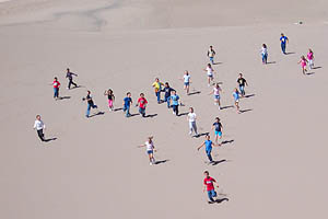 children running down dunes