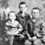 Black-and-white portrait photograph of one girl and two boys.