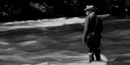 Black and white photo of Herbert Hoover fly-fishing in a river.