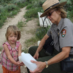 Teacher Ranger Teacher helps a thirsty hiker.