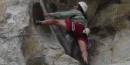 Climber on granite ledge.