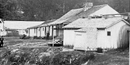 black and white photo of Rector's bathhouse, a small one story frame building near the edge of Hot Springs Creek