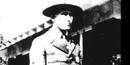 black and white head and shoulders shot of James Cary with ranger hat on and building in background