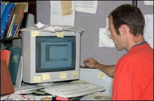  Poor workstation setup. This person must reach up and away from his desk to operate the mouse.