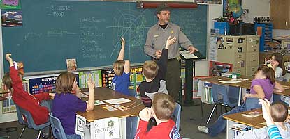 Park Ranger and school children interact in their classroom.